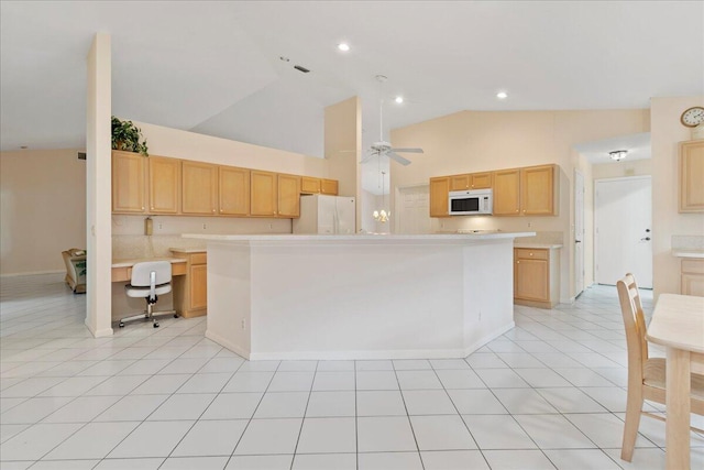 kitchen featuring white appliances, a center island, light brown cabinetry, and light tile patterned floors