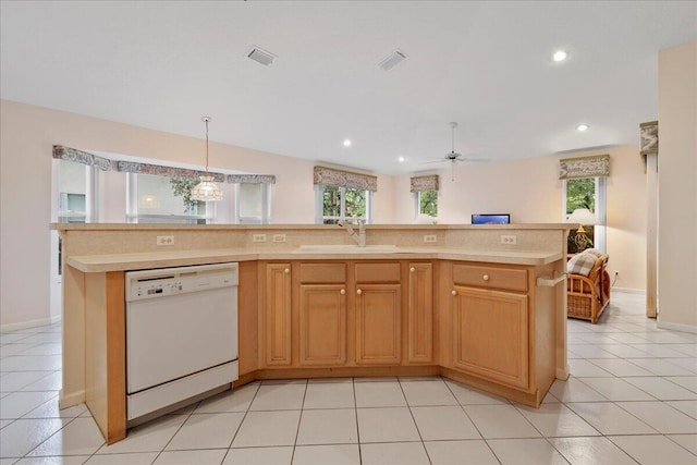 kitchen featuring sink, dishwasher, ceiling fan, a kitchen island with sink, and hanging light fixtures