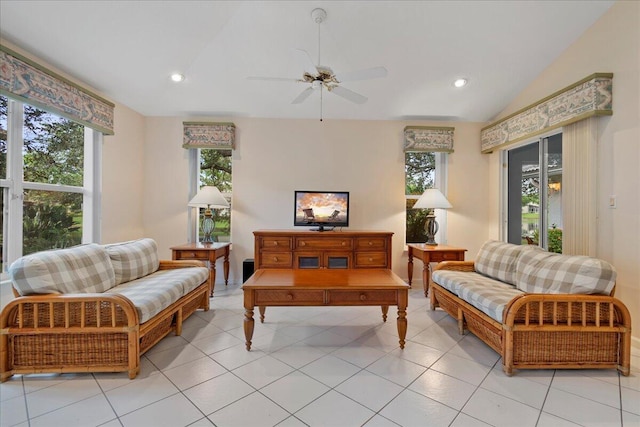 tiled living room featuring ceiling fan, lofted ceiling, and a wealth of natural light