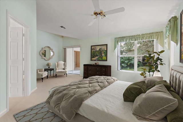 bedroom featuring light colored carpet and ceiling fan