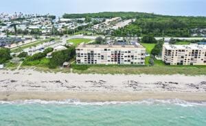 bird's eye view featuring a beach view and a water view