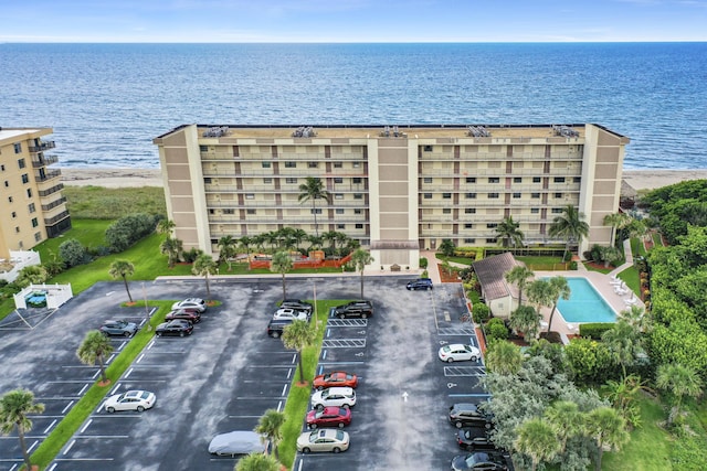 drone / aerial view with a water view and a beach view