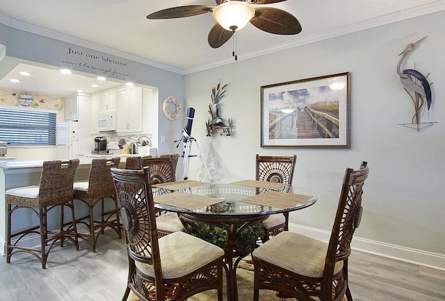 dining room with ornamental molding, light hardwood / wood-style floors, and ceiling fan