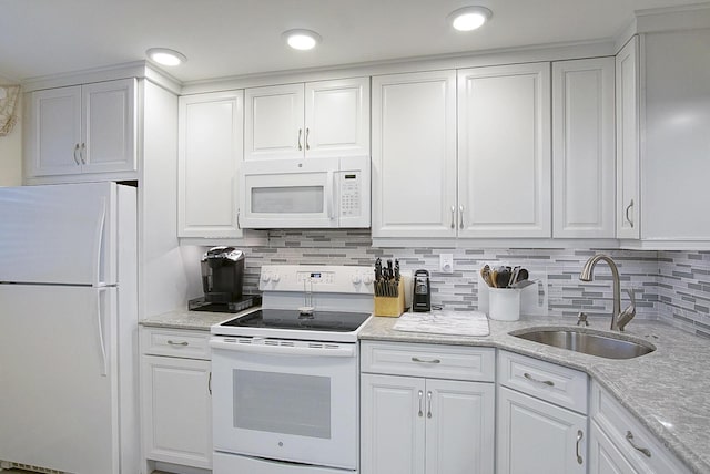 kitchen featuring white cabinetry, sink, backsplash, light stone counters, and white appliances