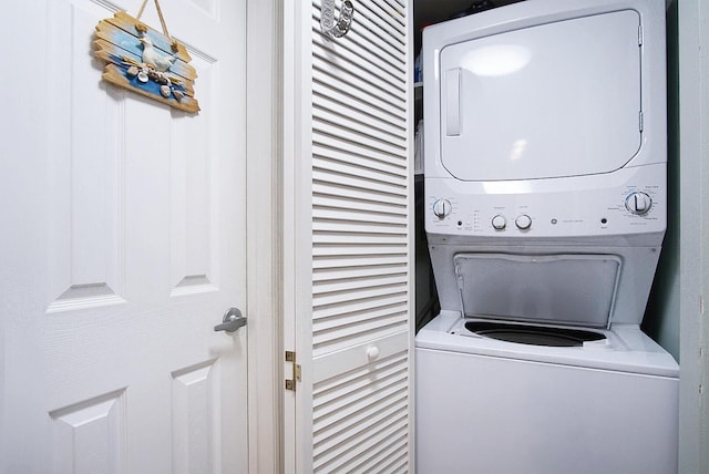 clothes washing area featuring stacked washer / dryer