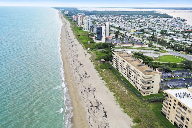 drone / aerial view with a water view and a view of the beach