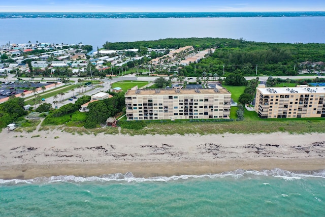 drone / aerial view featuring a beach view and a water view