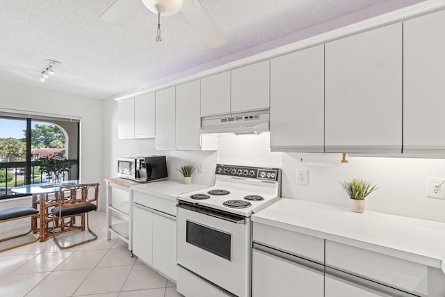 kitchen featuring light tile patterned floors, a textured ceiling, white cabinets, and white range with electric stovetop