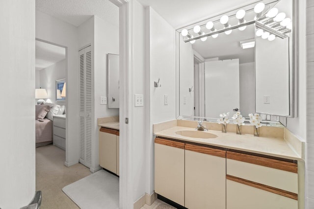 bathroom with vanity and a textured ceiling