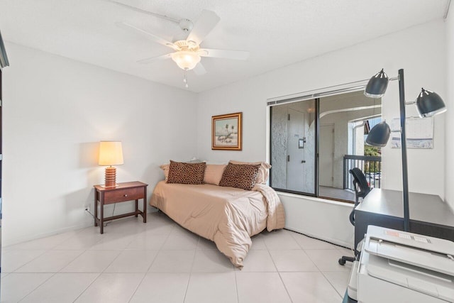 tiled bedroom featuring ceiling fan and a textured ceiling