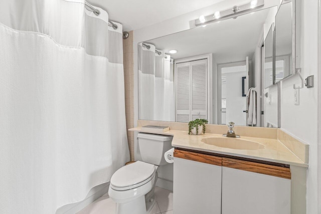 bathroom with vanity, tile patterned flooring, and toilet