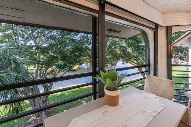 sunroom with a water view