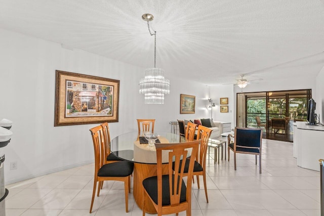 dining area with ceiling fan with notable chandelier, light tile patterned floors, and a textured ceiling