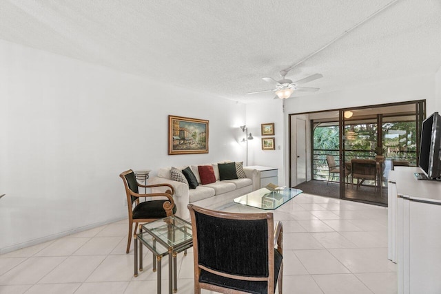 tiled living room with ceiling fan and a textured ceiling