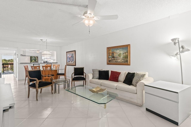 tiled living room with ceiling fan and a textured ceiling