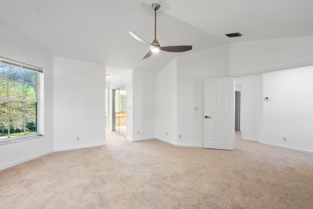 carpeted empty room featuring ceiling fan and vaulted ceiling