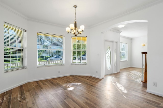 interior space featuring crown molding, hardwood / wood-style floors, and a notable chandelier