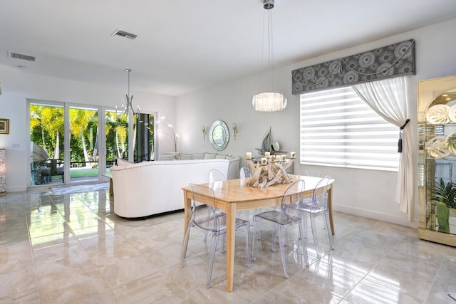 dining area featuring an inviting chandelier