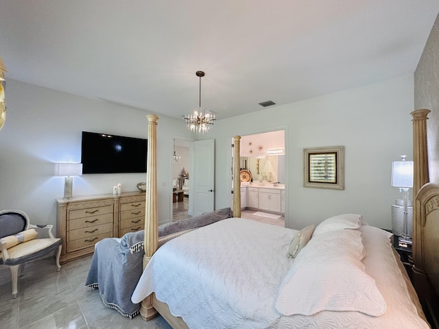 bedroom with ensuite bathroom, a chandelier, and ornate columns