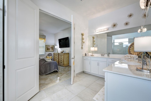 bathroom featuring a healthy amount of sunlight, tile patterned flooring, and vanity