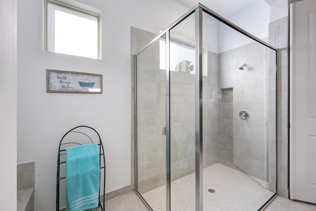 bathroom featuring a shower with door