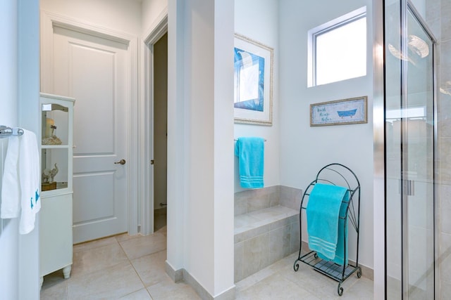 bathroom featuring walk in shower and tile patterned flooring