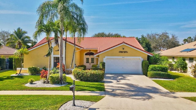 mediterranean / spanish home featuring a garage and a front lawn