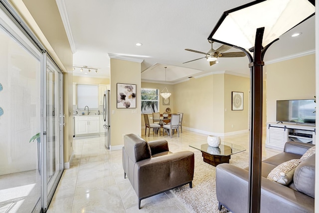 living room featuring sink, ornamental molding, and ceiling fan