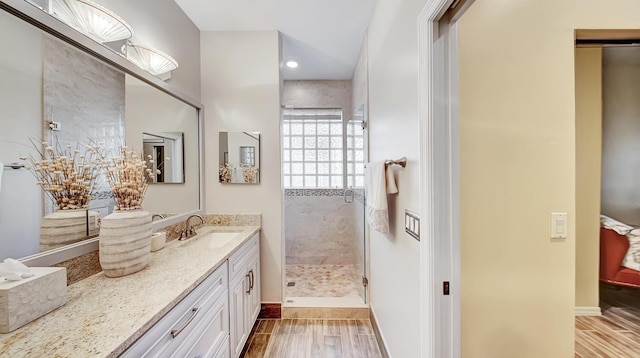 bathroom with vanity and tiled shower