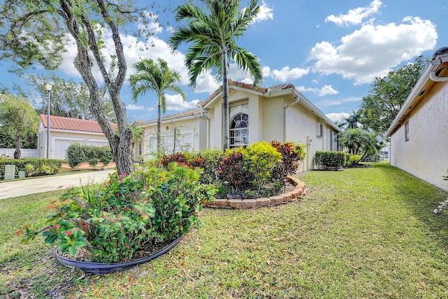 view of side of home with a garage and a yard