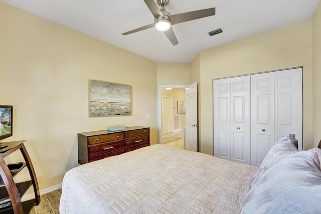 bedroom with light hardwood / wood-style floors, a closet, and ceiling fan