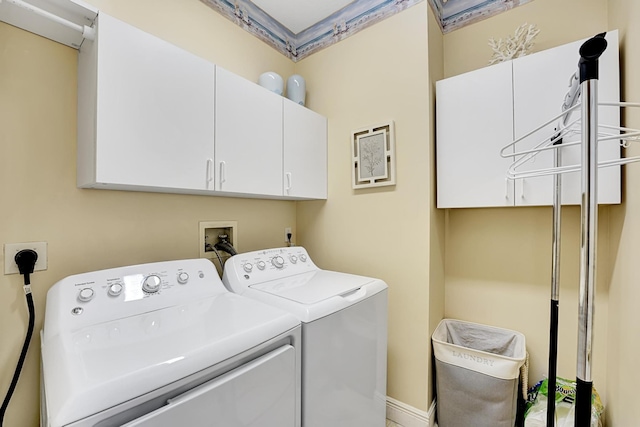 laundry room with cabinets and washing machine and dryer