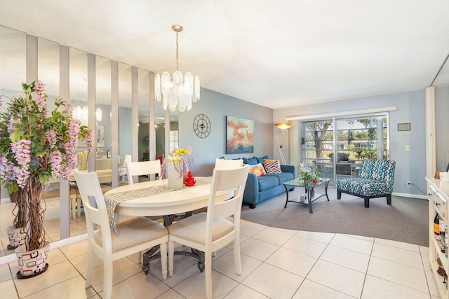 tiled dining room featuring a chandelier