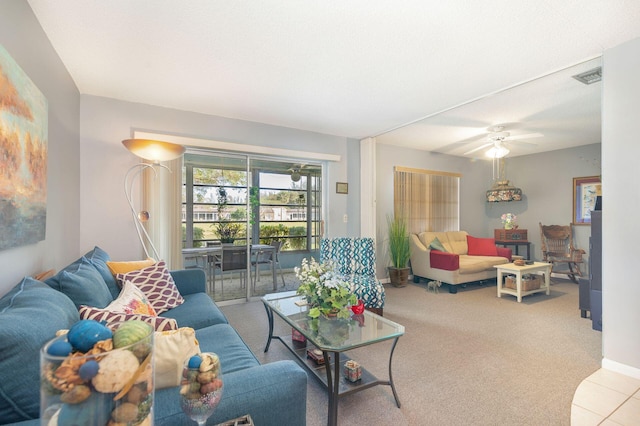 carpeted living room with ceiling fan