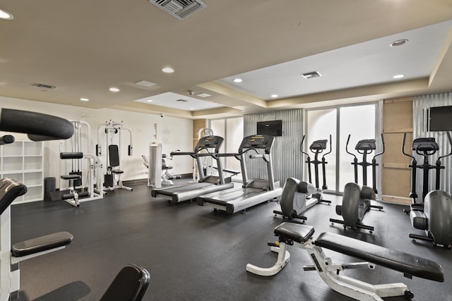 gym featuring a tray ceiling