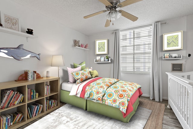 bedroom featuring ceiling fan, dark hardwood / wood-style floors, and a textured ceiling