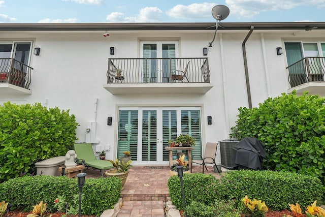 back of property with a patio area and a balcony