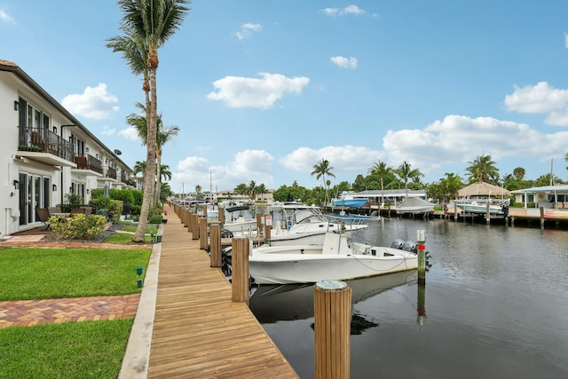 dock area featuring a water view and a yard