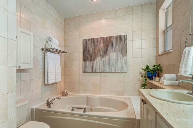 bathroom with tile walls, vanity, and a tub