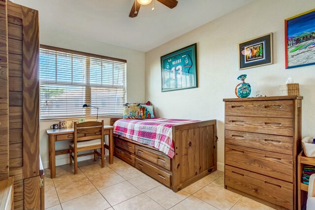 bedroom with vaulted ceiling, ceiling fan, and light tile patterned flooring