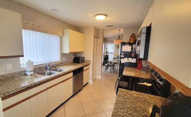 kitchen featuring decorative light fixtures, sink, white cabinets, light tile patterned floors, and stainless steel appliances