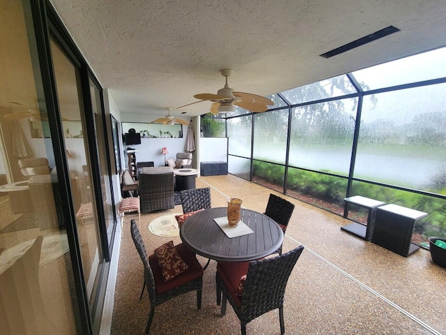 sunroom featuring ceiling fan