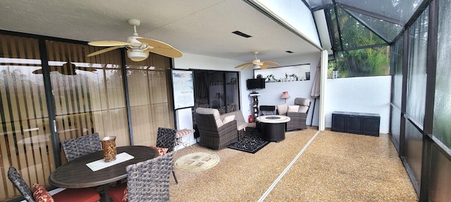 sunroom / solarium featuring ceiling fan and a healthy amount of sunlight