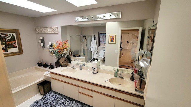 bathroom with vanity, tile patterned flooring, a skylight, and separate shower and tub