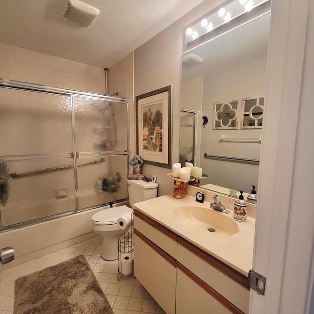 full bathroom featuring tile patterned flooring, vanity, shower / bath combination with glass door, and toilet