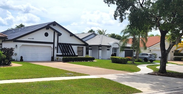 view of front of house featuring a garage and a front yard