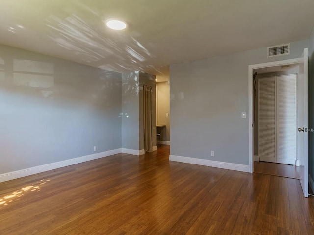 unfurnished room with dark hardwood / wood-style floors