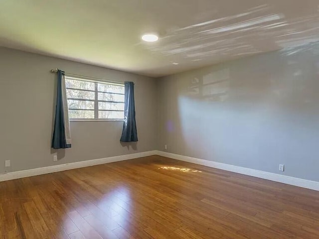 spare room with hardwood / wood-style flooring