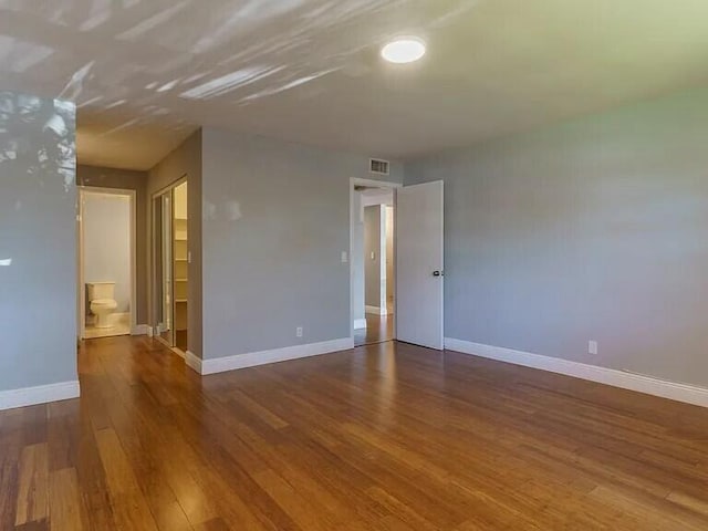 empty room with wood-type flooring