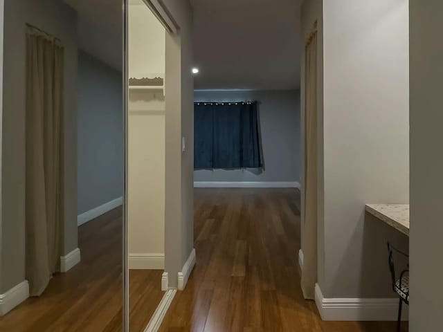 corridor with hardwood / wood-style floors